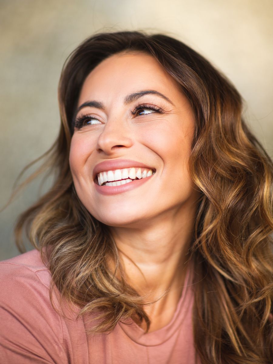 Woman wearing pink and has high cheekbones