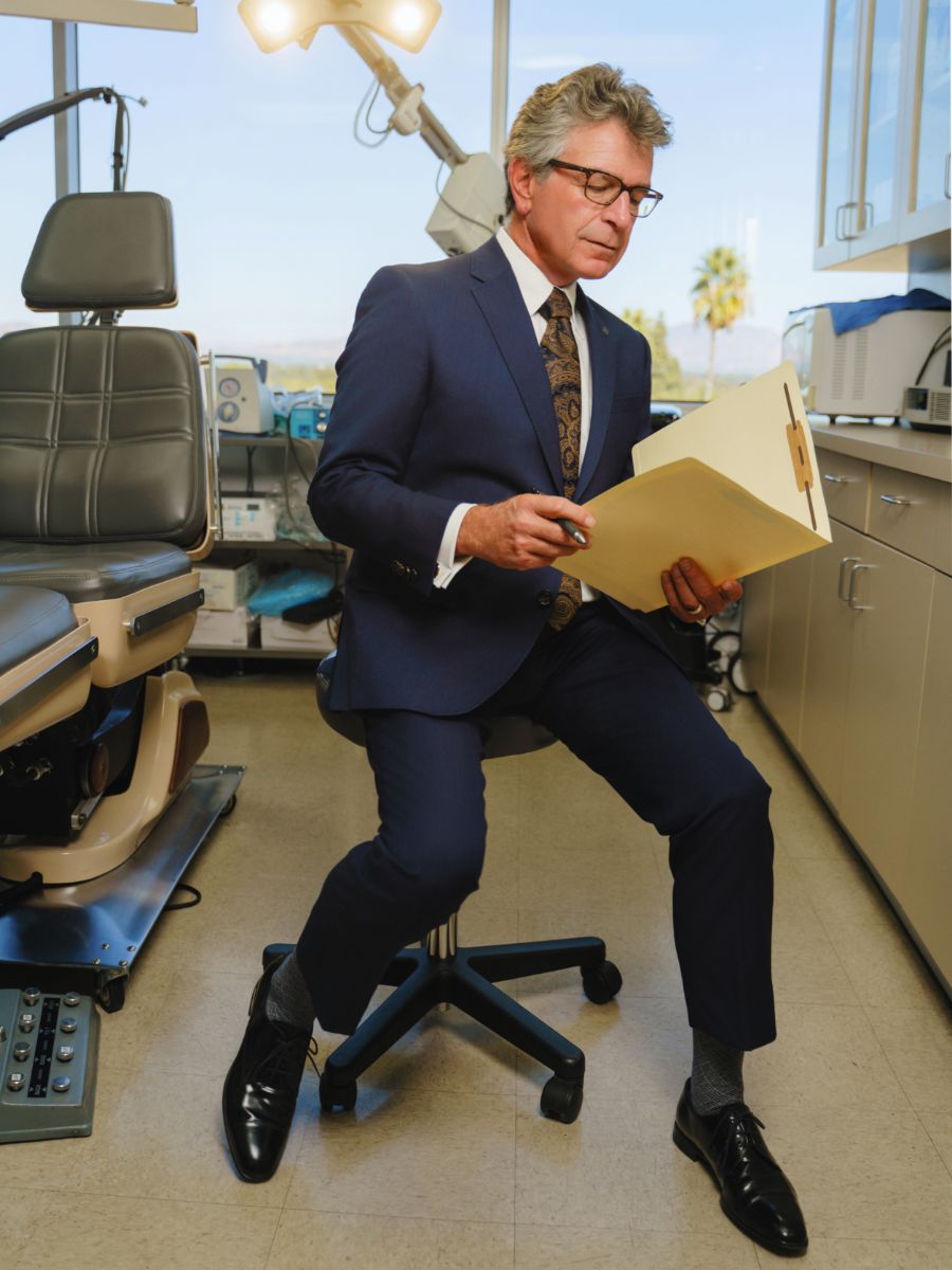 Michael A. Persky, MD in the OR reading a case file