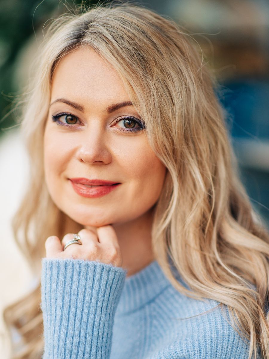 blond woman wearing a baby blue sweater