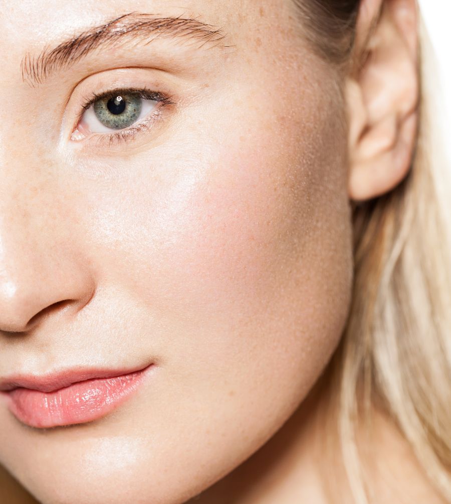 close up crop of a woman's cheek, jaw and ear