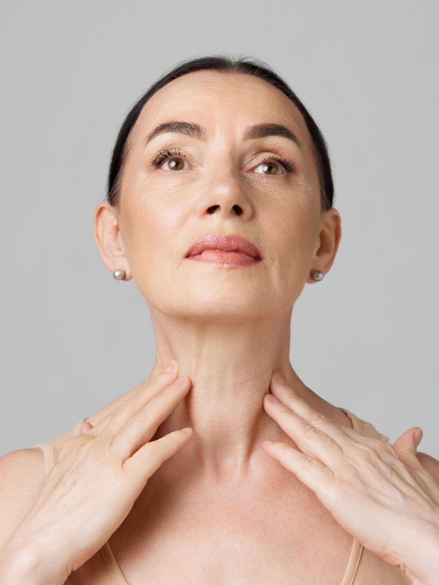 mature woman touching her neck