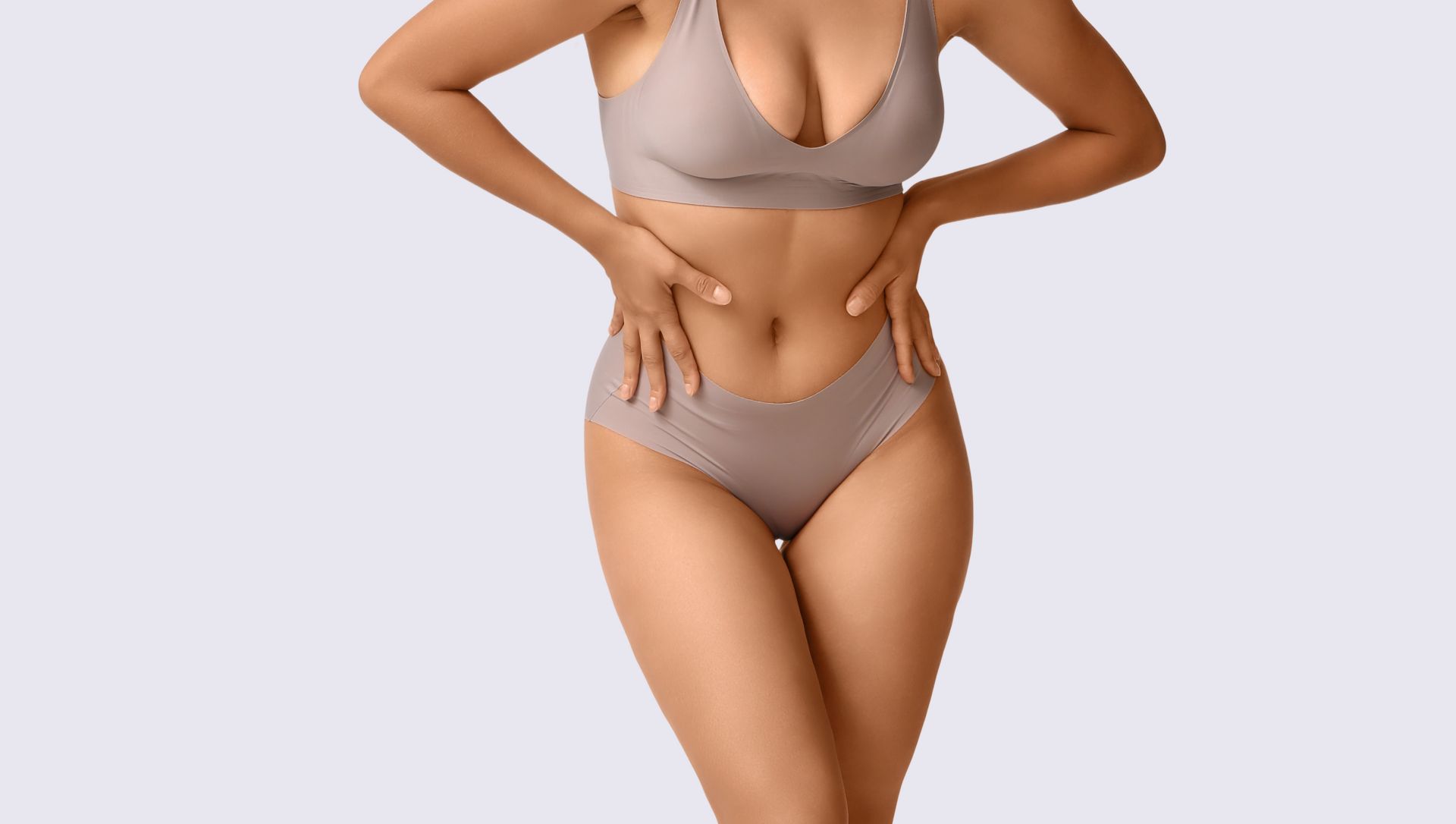 woman wearing a nude undergarment with her hands on her hips