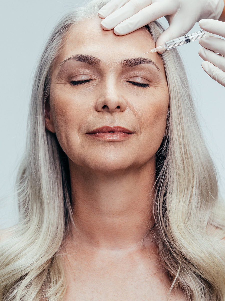 Woman getting an injection on her forehead